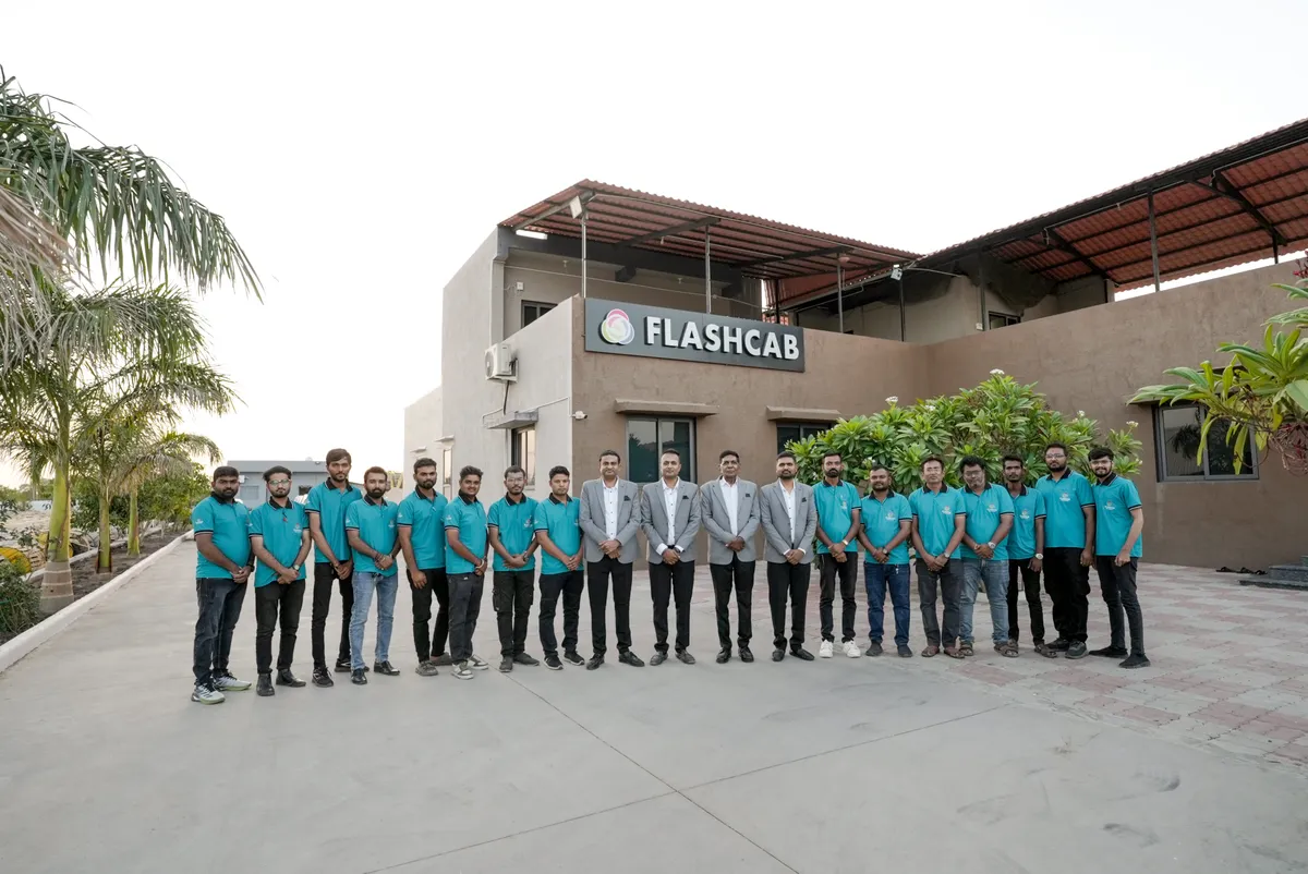 Flashcab Cables team posing in front of the main office building
